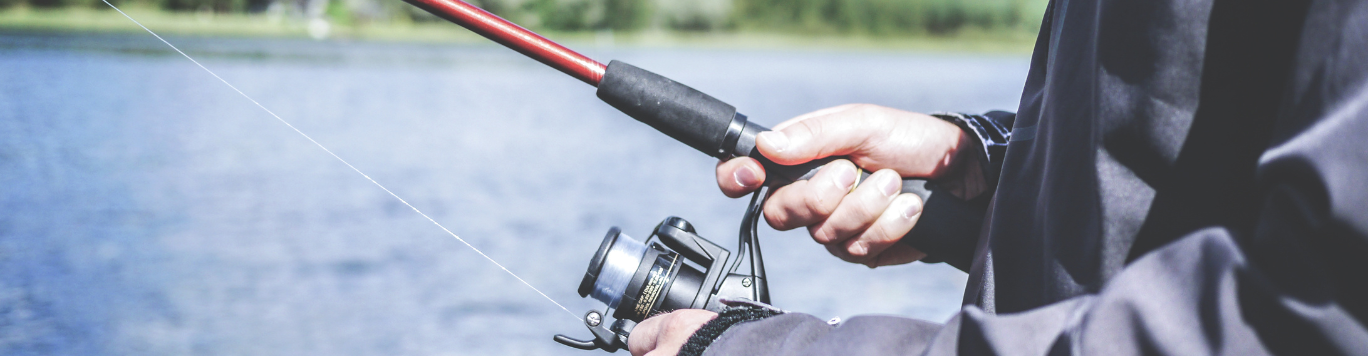 Baker's Gas Person fishing at a river