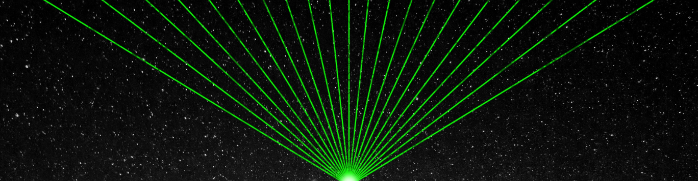 Baker's Gas Green lasers shooting into the night sky
