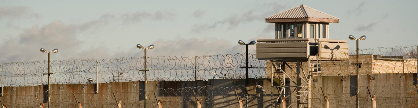 Baker's Gas Prison tower and barb-wire wall
