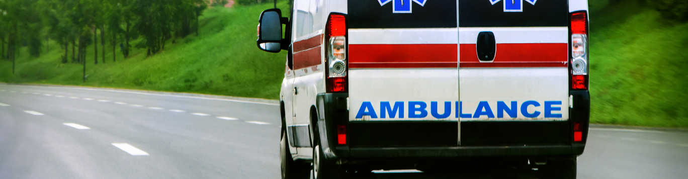 Baker's Gas Ambulance speeding down a road