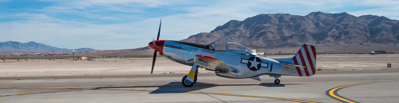 Baker's Gas Fighter plane taking off on runway