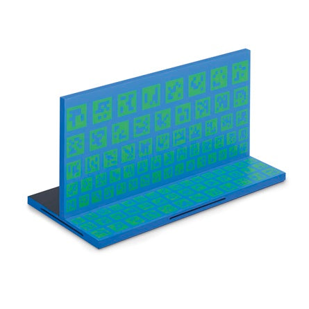 Blue and green metal workpiece with patterned squares for testing, labeled Miller AugmentedArc Workpiece