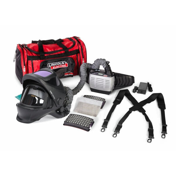 Baker's Gas Lincoln hard hat PAPR helmet with blower unit connected with a white background. Filters and should strap sit to the right and a red duffle bag to the left.